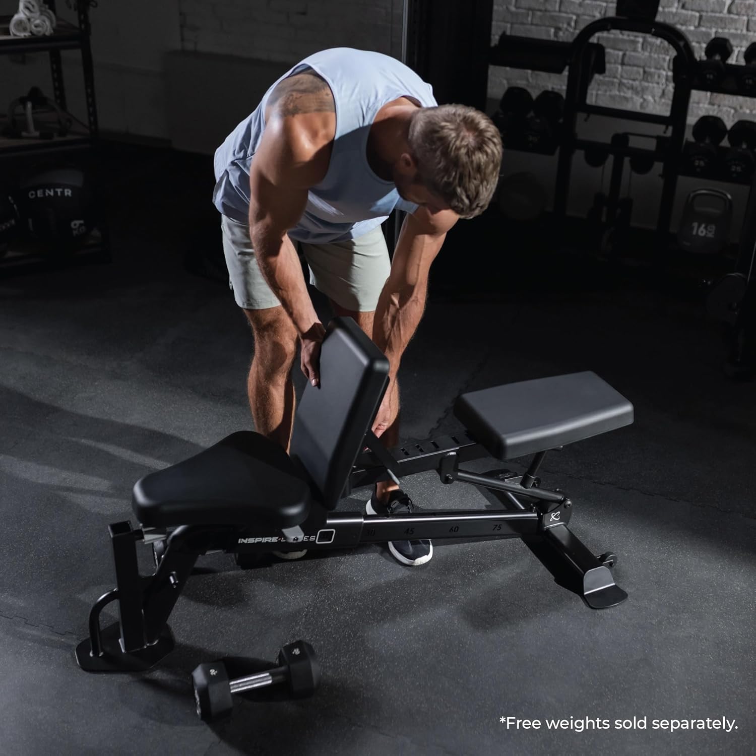 Man adjusting a weight bench in a gym setting