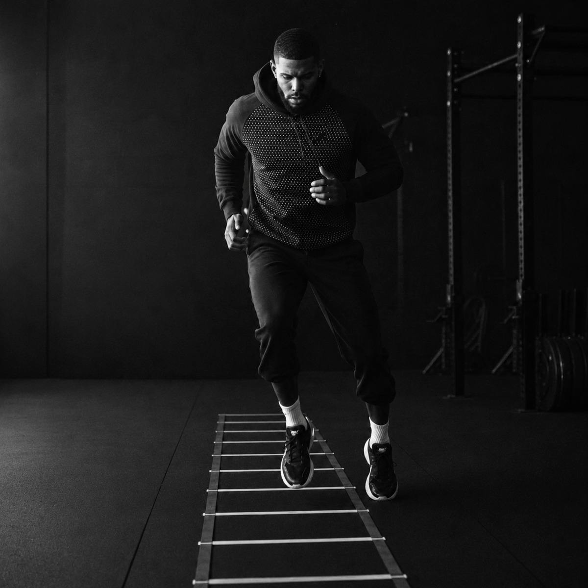 Athlete using the agility ladder for speed training in a gym