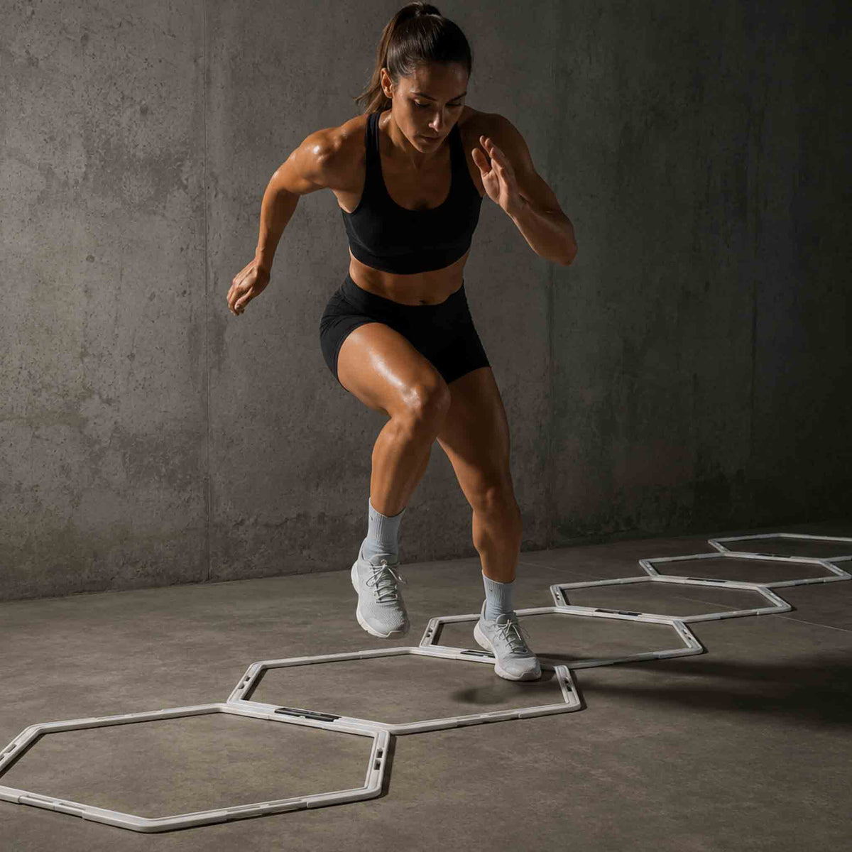 Athlete training footwork through flat hexagon hurdles